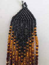 Charger l'image dans la galerie, Beaded earring with black, brown, and gold beads on a white background