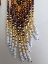 Charger l'image dans la galerie, gold, brown, and white Indigenous beaded earrings on a light gray background