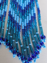 Load image into Gallery viewer, Close-up of blue and green beaded earrings on a light background
